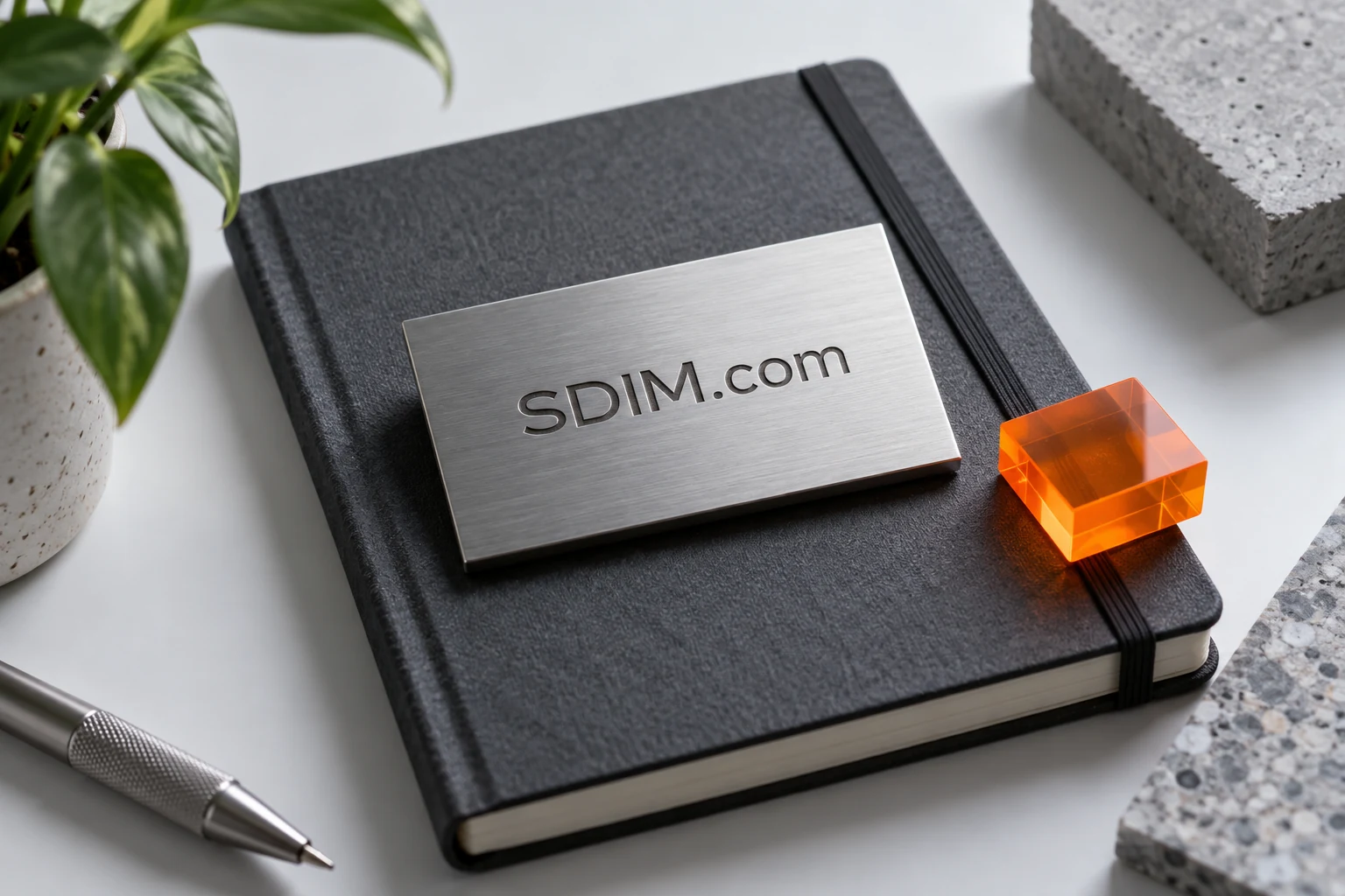 SDIM.com identity on graphite stationery and a metal card